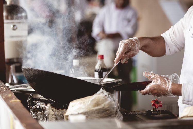 Closeup shot of a chef cooking with a blurred background